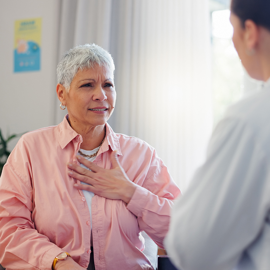 woman with heart palpitations talking with cardiologist